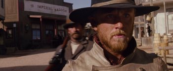 Movie still from “3:10 to Yuma” (2007), directed by James Mangold – A man with a beard wearing a hat and holding a gun; Close Up shot, Low angle