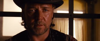 Movie still from “3:10 to Yuma” (2007), directed by James Mangold – A person wearing a hat and looking at the camera; Close Up shot, Over the shoulder angle