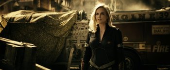 Movie still from “The Boys” (2019), created by Eric Kripke – A beautiful blonde woman in a black outfit; Medium shot, Over the shoulder angle