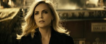 A woman with blonde hair is looking to her left