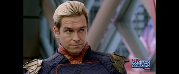 Movie still from “The Boys” (2019), created by Eric Kripke – A man that is wearing a suit; Close Up shot, Over the shoulder angle