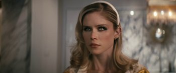 Movie still from “The Boys” (2019), created by Eric Kripke – A beautiful woman with long blonde hair and green eyes; Close Up shot, Over the shoulder angle