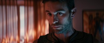 Movie still from “The Boys” (2019), created by Eric Kripke – A man's face in front of a blurry background; Close Up shot, Over the shoulder angle