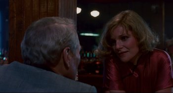 Movie still from “The Color of Money” (1986), directed by Martin Scorsese – Two people sitting at a table in front of each other; Close Up shot, Over the shoulder angle