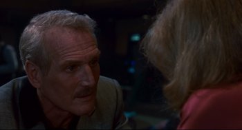 Movie still from “The Color of Money” (1986), directed by Martin Scorsese – An older man talking to a woman in a dark room; Close Up shot, Over the shoulder angle