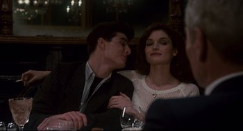 Movie still from “The Color of Money” (1986), directed by Martin Scorsese – A man and a woman sitting next to each other at a table; Medium shot, Over the shoulder angle