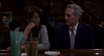 Movie still from “The Color of Money” (1986), directed by Martin Scorsese – A man and a woman sitting at a dinner table; Close Up shot, Over the shoulder angle