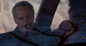 Movie still from “The Color of Money” (1986), directed by Martin Scorsese – A man is looking out of a car window at dusk; Close Up shot, Over the shoulder angle