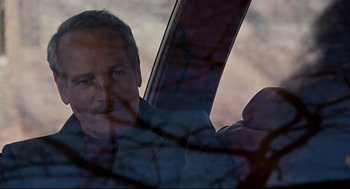 Movie still from “The Color of Money” (1986), directed by Martin Scorsese – A man is looking out of a car window at sunset; Close Up shot, Over the shoulder angle