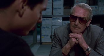 Movie still from “The Color of Money” (1986), directed by Martin Scorsese – An older man in a suit and sunglasses talking to a young man; Close Up shot, Over the shoulder angle
