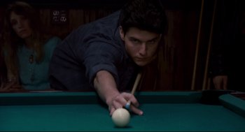 Movie still from “The Color of Money” (1986), directed by Martin Scorsese – A young man playing a game of billiards; Close Up shot, Low angle