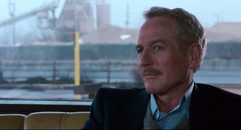 Movie still from “The Color of Money” (1986), directed by Martin Scorsese – A person wearing a suit and tie; Close Up shot, Over the shoulder angle