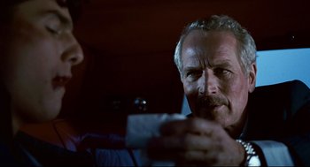 Movie still from “The Color of Money” (1986), directed by Martin Scorsese – A man holding a piece of paper in his hand; Close Up shot, Over the shoulder angle