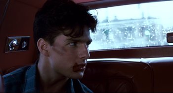 Movie still from “The Color of Money” (1986), directed by Martin Scorsese – A young man with a mustache sitting in a car; Close Up shot, Over the shoulder angle