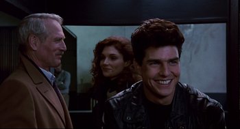 Movie still from “The Color of Money” (1986), directed by Martin Scorsese – A group of people standing next to each other in a room; Close Up shot, Over the shoulder angle