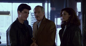 Movie still from “The Color of Money” (1986), directed by Martin Scorsese – A group of people standing next to each other in a room; Medium shot, Over the shoulder angle