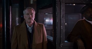 Movie still from “The Color of Money” (1986), directed by Martin Scorsese – An older man standing in front of a window; Medium shot, Over the shoulder angle