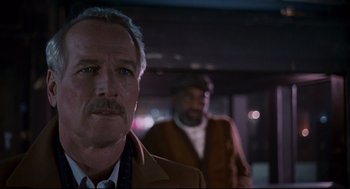 Movie still from “The Color of Money” (1986), directed by Martin Scorsese – A man with a mustache standing next to another man; Close Up shot, Low angle