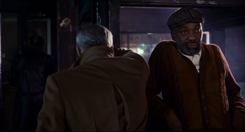 Movie still from “The Color of Money” (1986), directed by Martin Scorsese – Two older men sitting on a bus at night; Medium shot, Over the shoulder angle