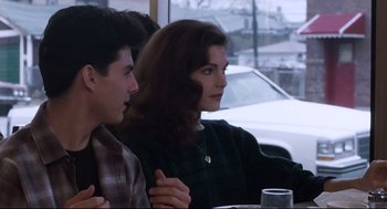 Movie still from “The Color of Money” (1986), directed by Martin Scorsese – A woman sitting next to a man at a table; Medium shot, Over the shoulder angle