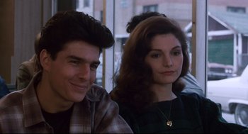 Movie still from “The Color of Money” (1986), directed by Martin Scorsese – A man and a woman sitting next to each other; Close Up shot, Over the shoulder angle