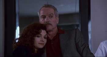 Movie still from “The Color of Money” (1986), directed by Martin Scorsese – A man and a woman pose for a picture; Close Up shot, Low angle