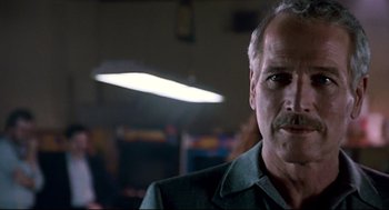 Movie still from “The Color of Money” (1986), directed by Martin Scorsese – An older man with a mustache is looking at the camera; Close Up shot, Low angle