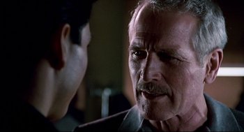 Movie still from “The Color of Money” (1986), directed by Martin Scorsese – An older man with a mustache talking to a younger man; Close Up shot, Over the shoulder angle