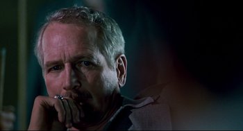 Movie still from “The Color of Money” (1986), directed by Martin Scorsese – A person holding his hand up to his mouth; Close Up shot, Over the shoulder angle