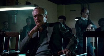 Movie still from “The Color of Money” (1986), directed by Martin Scorsese – A man sitting in a chair in a room; Medium shot, Low angle