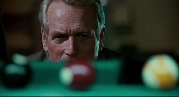 Movie still from “The Color of Money” (1986), directed by Martin Scorsese – An older man is looking at a ball on a pool table; Close Up shot, Over the shoulder angle