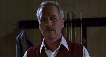 Movie still from “The Color of Money” (1986), directed by Martin Scorsese – An older man wearing a red vest and a white shirt; Close Up shot, Low angle