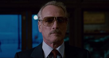 Movie still from “The Color of Money” (1986), directed by Martin Scorsese – An older man wearing a suit and sunglasses; Close Up shot, Low angle