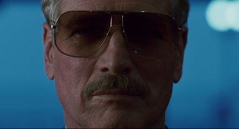 Movie still from “The Color of Money” (1986), directed by Martin Scorsese – An older man with a mustache wearing glasses; Close Up shot, Low angle