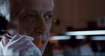Movie still from “The Color of Money” (1986), directed by Martin Scorsese – An older man holding an orange in his mouth; Close Up shot, Low angle
