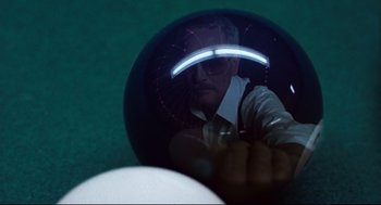 Movie still from “The Color of Money” (1986), directed by Martin Scorsese – A man is reflected in the mirror of a ball; Extreme Close Up shot, Overhead angle