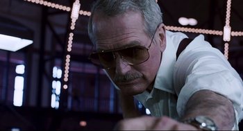 Movie still from “The Color of Money” (1986), directed by Martin Scorsese – An older man wearing sunglasses and a white shirt; Close Up shot, Low angle