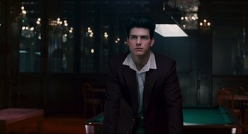 Movie still from “The Color of Money” (1986), directed by Martin Scorsese – A man in a suit and tie standing in front of a pool table; Medium shot, Over the shoulder angle