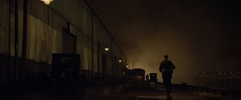 Movie still from “The Curious Case of Benjamin Button” (2008), directed by David Fincher – A man walking down a street at night; Extreme Wide shot, Low angle