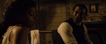 Movie still from “The Curious Case of Benjamin Button” (2008), directed by David Fincher – A man sitting next to another man in a dark room; Close Up shot, Over the shoulder angle