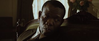 Movie still from “The Curious Case of Benjamin Button” (2008), directed by David Fincher – A person sitting in a chair; Close Up shot, Over the shoulder angle