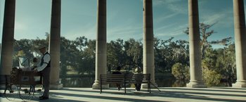 Movie still from “The Curious Case of Benjamin Button” (2008), directed by David Fincher – Two people sitting on a park bench near a lake; Extreme Wide shot, Low angle