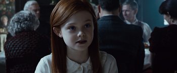 Movie still from “The Curious Case of Benjamin Button” (2008), directed by David Fincher – A little girl with long red hair wearing a white shirt; Close Up shot, Over the shoulder angle