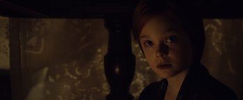 Movie still from “The Curious Case of Benjamin Button” (2008), directed by David Fincher – A young boy with blue eyes stares into the camera; Close Up shot, Over the shoulder angle
