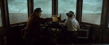 Movie still from “The Curious Case of Benjamin Button” (2008), directed by David Fincher – Two men in hats are working on a boat; Medium shot, Low angle