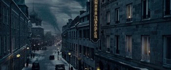 Movie still from “The Curious Case of Benjamin Button” (2008), directed by David Fincher – A street scene with a car driving down the street; Extreme Wide shot, High angle