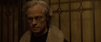 Movie still from “The Curious Case of Benjamin Button” (2008), directed by David Fincher – An older man wearing glasses and a fur coat; Close Up shot, Low angle