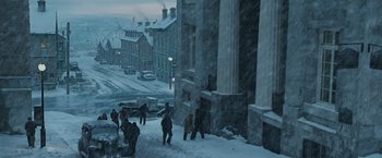 Movie still from “The Curious Case of Benjamin Button” (2008), directed by David Fincher – A group of people walking down a snowy sidewalk; Extreme Wide shot, High angle
