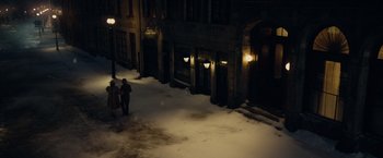 Movie still from “The Curious Case of Benjamin Button” (2008), directed by David Fincher – A couple of people walking down a snowy sidewalk; Extreme Wide shot, High angle