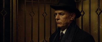 Movie still from “The Curious Case of Benjamin Button” (2008), directed by David Fincher – An older man wearing a black hat and a black tie; Close Up shot, Low angle